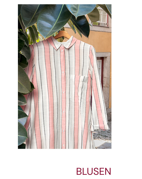 Bluse hängt neben Blaettern